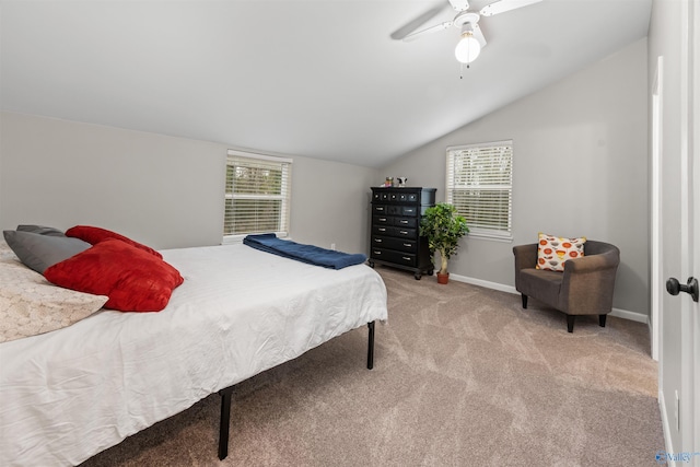 bedroom with light carpet, ceiling fan, baseboards, and vaulted ceiling