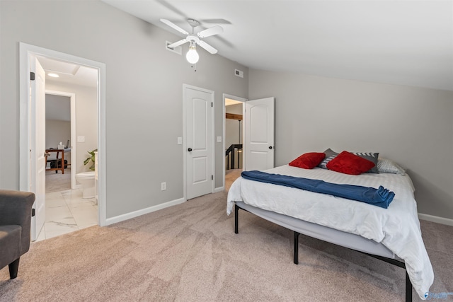 bedroom featuring attic access, baseboards, a ceiling fan, connected bathroom, and vaulted ceiling