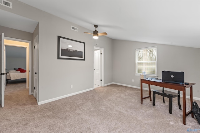 home office featuring vaulted ceiling, light carpet, visible vents, and baseboards