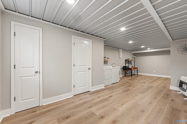 finished basement with baseboards, light wood-style flooring, washing machine and clothes dryer, heating unit, and recessed lighting