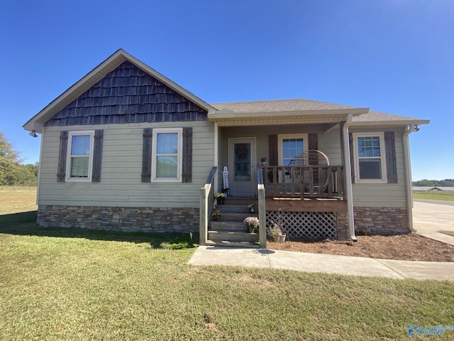 view of front of home featuring covered porch and a front yard