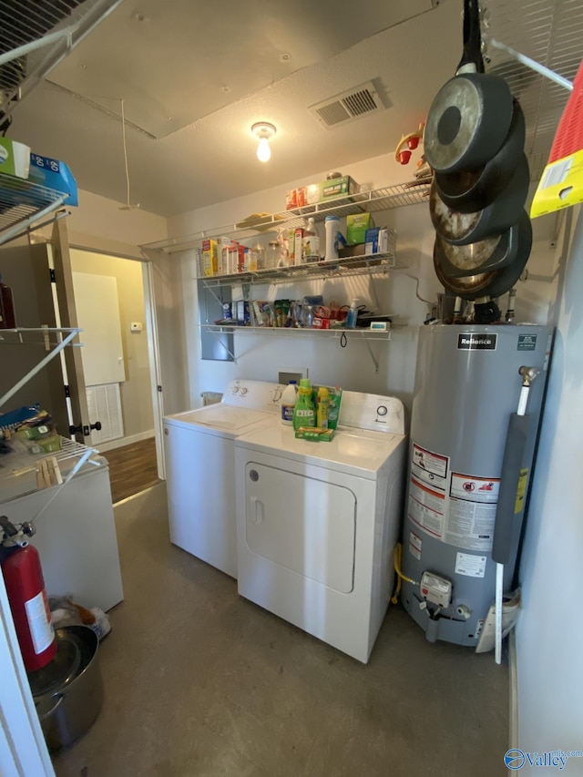 washroom featuring washer and clothes dryer and gas water heater