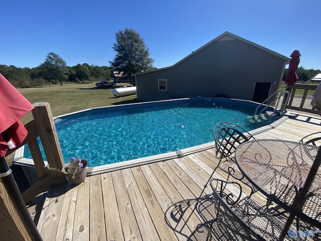 view of pool with a wooden deck