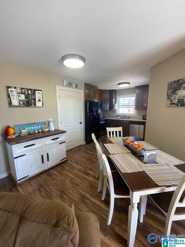 dining room featuring sink and dark hardwood / wood-style floors