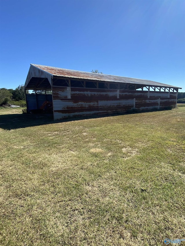 view of outdoor structure featuring a lawn