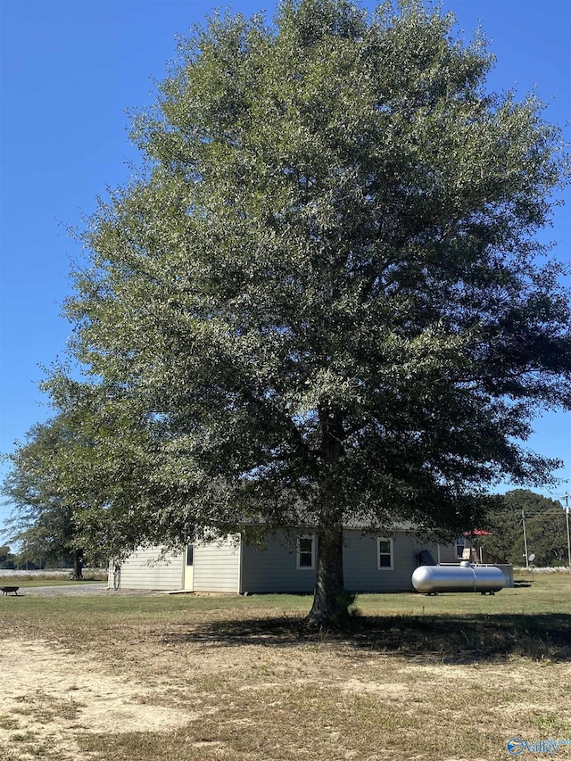 view of side of home with a lawn