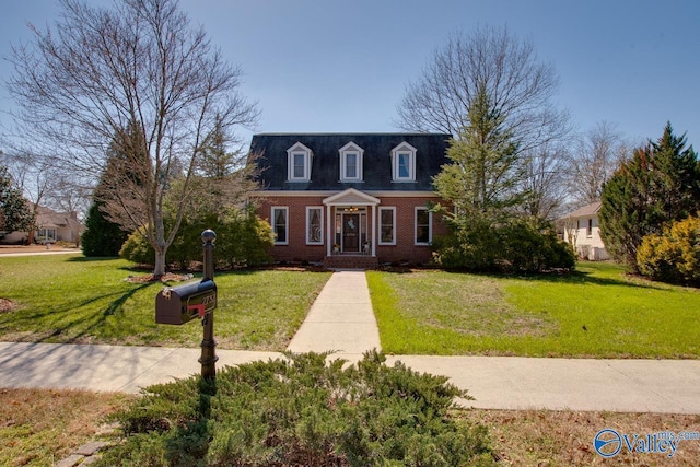 cape cod house with brick siding and a front lawn