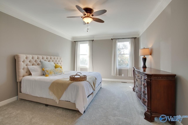 bedroom featuring light carpet, ceiling fan, baseboards, and crown molding