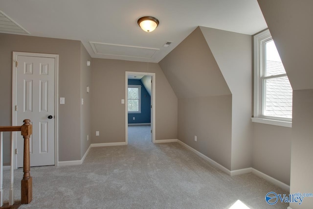 additional living space featuring vaulted ceiling, carpet floors, visible vents, and baseboards