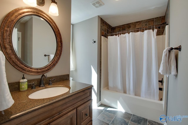 bathroom with shower / bath combo, visible vents, and vanity