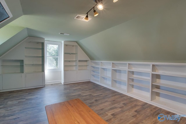 bonus room featuring dark wood-style floors, vaulted ceiling, and visible vents