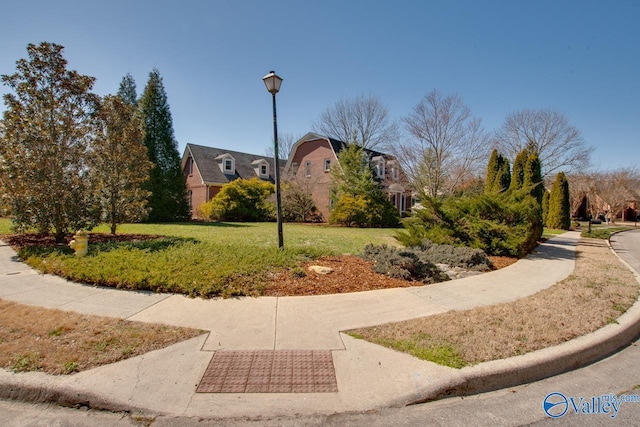 view of property's community featuring a yard