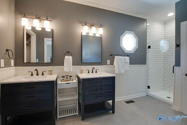 full bathroom with visible vents, a wainscoted wall, a shower stall, and vanity