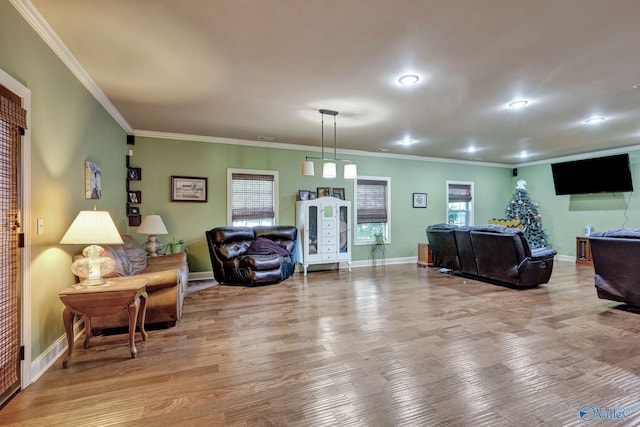 living area with crown molding, wood finished floors, and baseboards