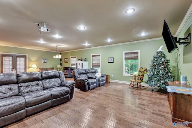 living room featuring ornamental molding, light wood finished floors, and recessed lighting