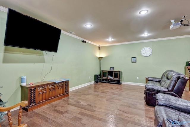 living area with light wood finished floors, baseboards, visible vents, and ornamental molding