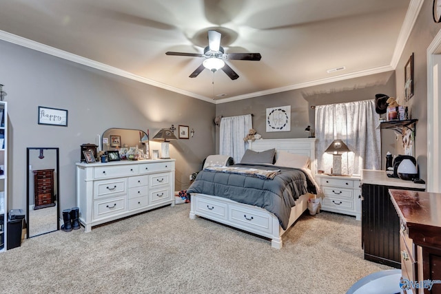 carpeted bedroom featuring ornamental molding and a ceiling fan