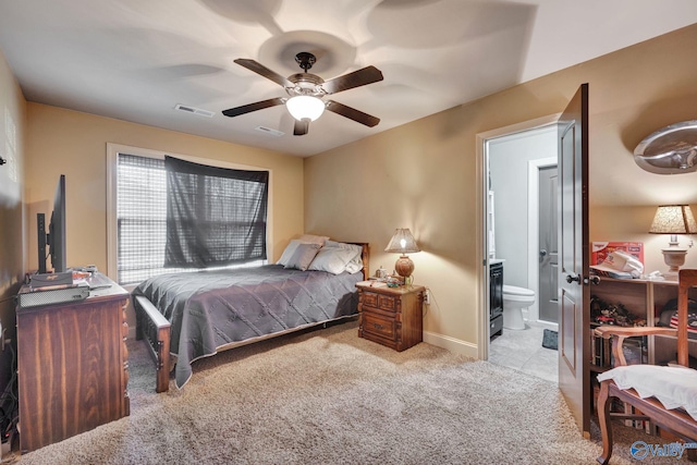 bedroom featuring ensuite bathroom, carpet flooring, visible vents, and a ceiling fan