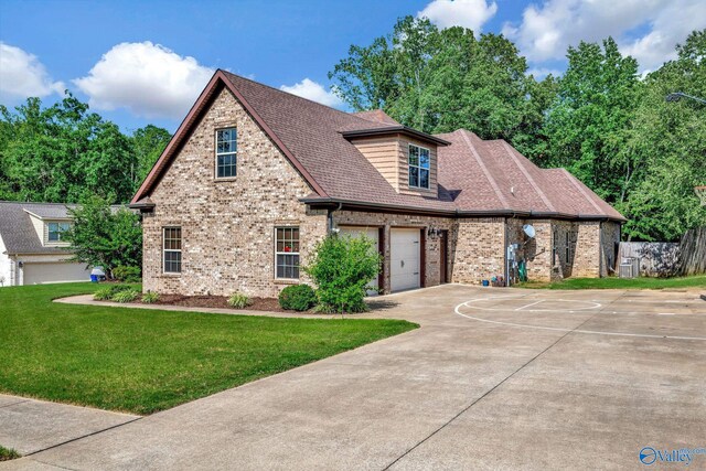 view of front facade with a garage and a front lawn