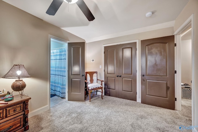 living area with carpet and ceiling fan