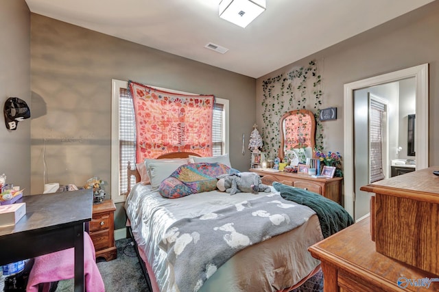 bedroom with carpet floors and visible vents