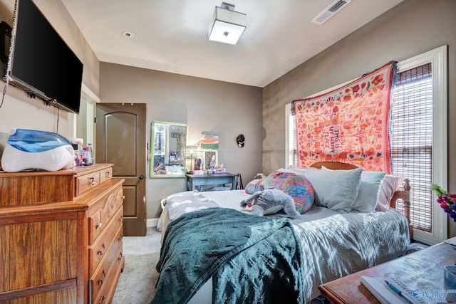 bedroom featuring light carpet, baseboards, and visible vents