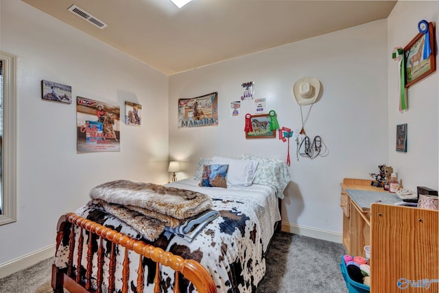 carpeted bedroom featuring visible vents and baseboards