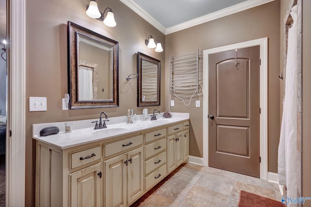 bathroom with ornamental molding, a sink, baseboards, and double vanity