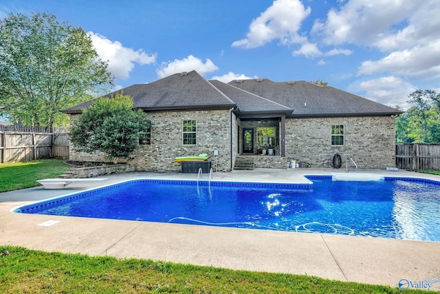 view of pool featuring a diving board, a patio area, a fenced backyard, and a fenced in pool