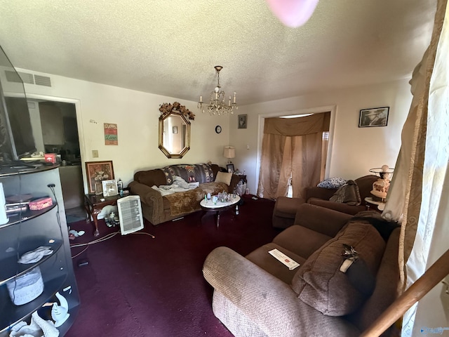 504 Joseph T Robinson, Gadsden, AL 35901 - living room with visible vents, a notable chandelier, and a textured ceiling