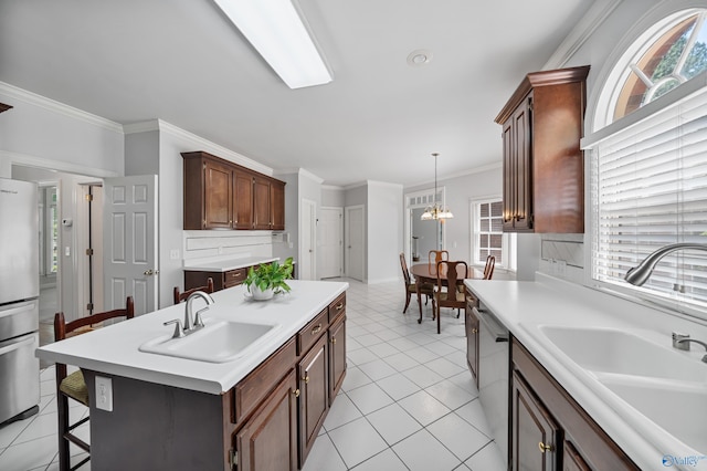 2600 SE Calumet Dr SE, Brownsboro, AL 35741 - kitchen with a sink, appliances with stainless steel finishes, a kitchen island with sink, light countertops, and ornamental molding
