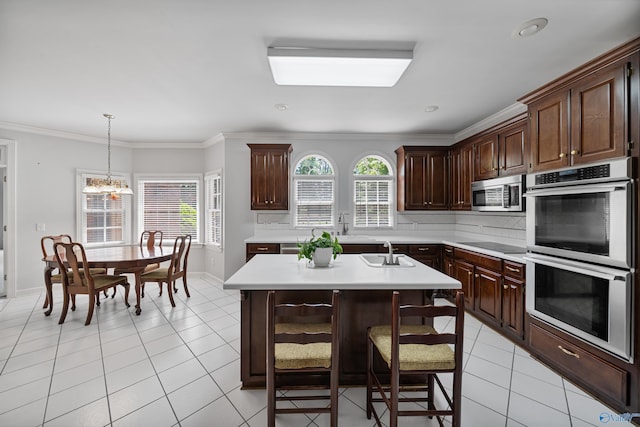 2600 SE Calumet Dr SE, Brownsboro, AL 35741 - kitchen featuring appliances with stainless steel finishes, light countertops, plenty of natural light, light tile patterned floors, and ornamental molding