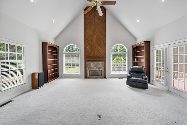 2600 SE Calumet Dr SE, Brownsboro, AL 35741 - unfurnished living room featuring high vaulted ceiling, carpet floors, a fireplace with flush hearth, ceiling fan, and healthy amount of natural light