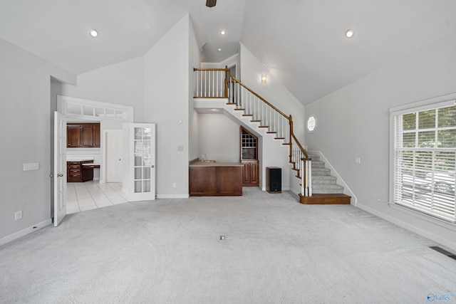 2600 SE Calumet Dr SE, Brownsboro, AL 35741 - unfurnished living room featuring stairway, high vaulted ceiling, light carpet, baseboards, and recessed lighting