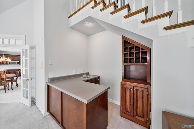 2600 SE Calumet Dr SE, Brownsboro, AL 35741 - bar area with stainless steel microwave, a high ceiling, light colored carpet, baseboards, and a sink