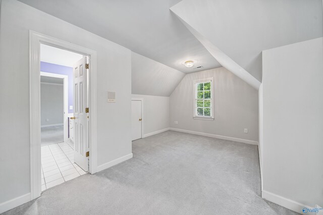 2600 SE Calumet Dr SE, Brownsboro, AL 35741 - bonus room featuring carpet flooring, vaulted ceiling, baseboards, and tile patterned floors