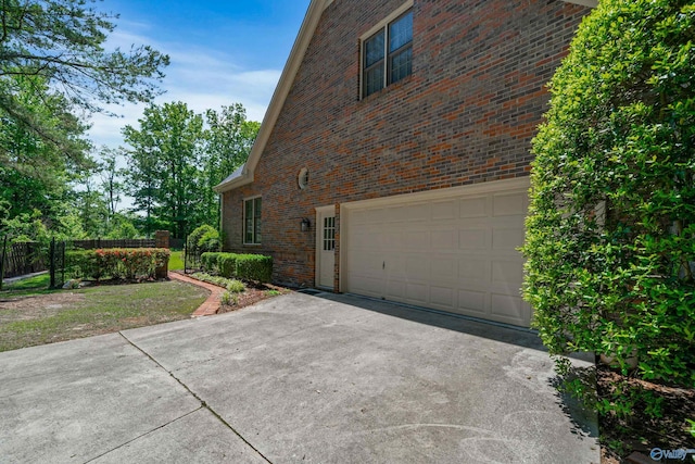 2600 SE Calumet Dr SE, Brownsboro, AL 35741 - view of side of home featuring brick siding, an attached garage, and driveway
