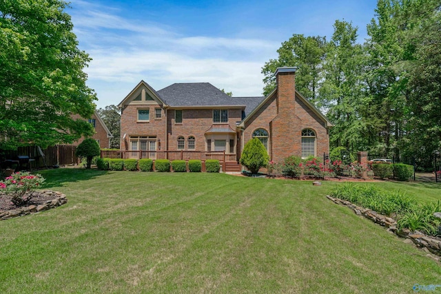2600 SE Calumet Dr SE, Brownsboro, AL 35741 - back of property with a chimney, brick siding, and a deck