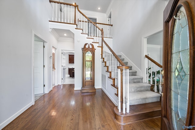 2600 SE Calumet Dr SE, Brownsboro, AL 35741 - foyer entrance featuring a high ceiling, crown molding, stairway, wood finished floors, and baseboards