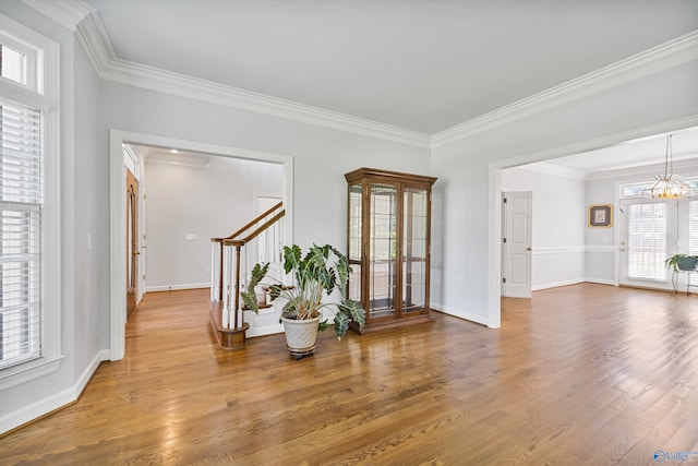 2600 SE Calumet Dr SE, Brownsboro, AL 35741 - entryway featuring a chandelier, ornamental molding, stairs, wood finished floors, and baseboards