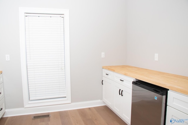 bar with white cabinetry, light wood-type flooring, wood counters, and dishwasher