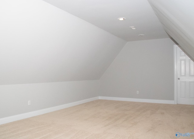 bonus room featuring vaulted ceiling and carpet flooring