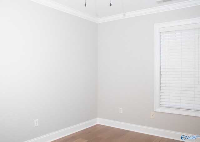 unfurnished room featuring crown molding and hardwood / wood-style floors