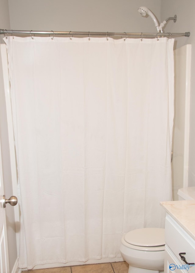 bathroom with tile patterned floors, vanity, and toilet