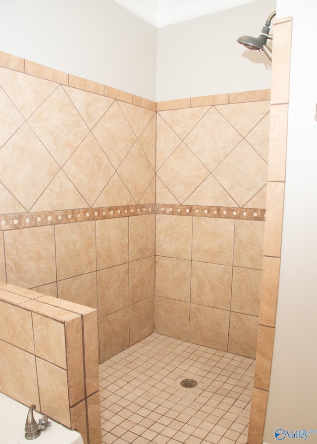 bathroom with crown molding and a tile shower