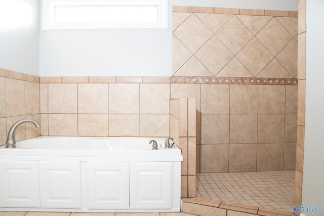 bathroom featuring independent shower and bath