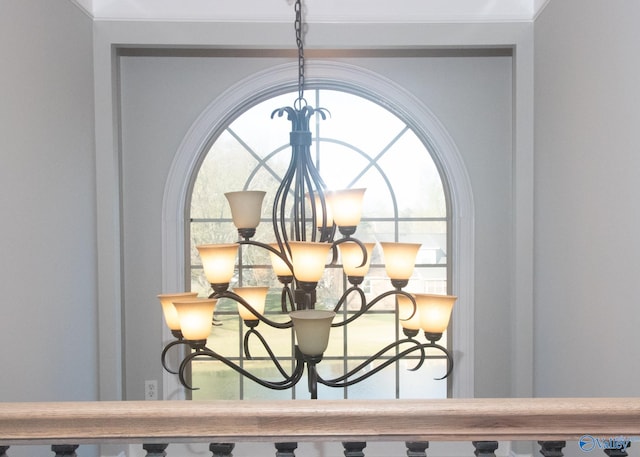 details with crown molding and a chandelier