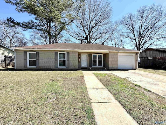 single story home featuring a front yard, an attached garage, brick siding, and driveway