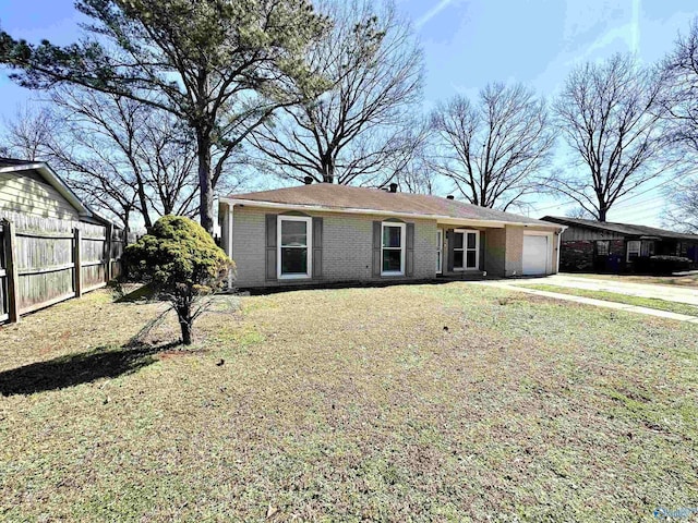 single story home with driveway, fence, a front yard, an attached garage, and brick siding