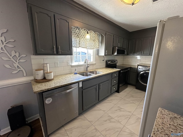 kitchen featuring a sink, washer / clothes dryer, marble finish floor, and appliances with stainless steel finishes